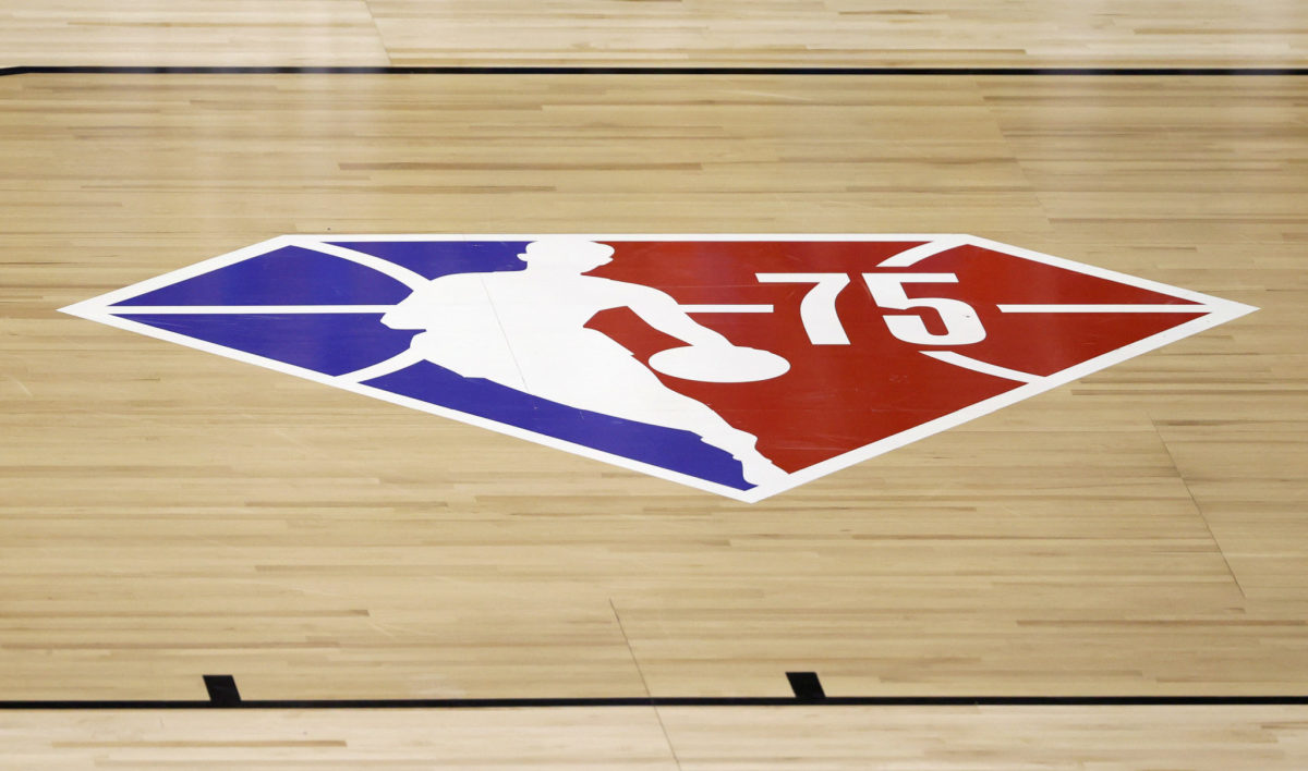 The NBA 75 logo is displayed on a basketball court.