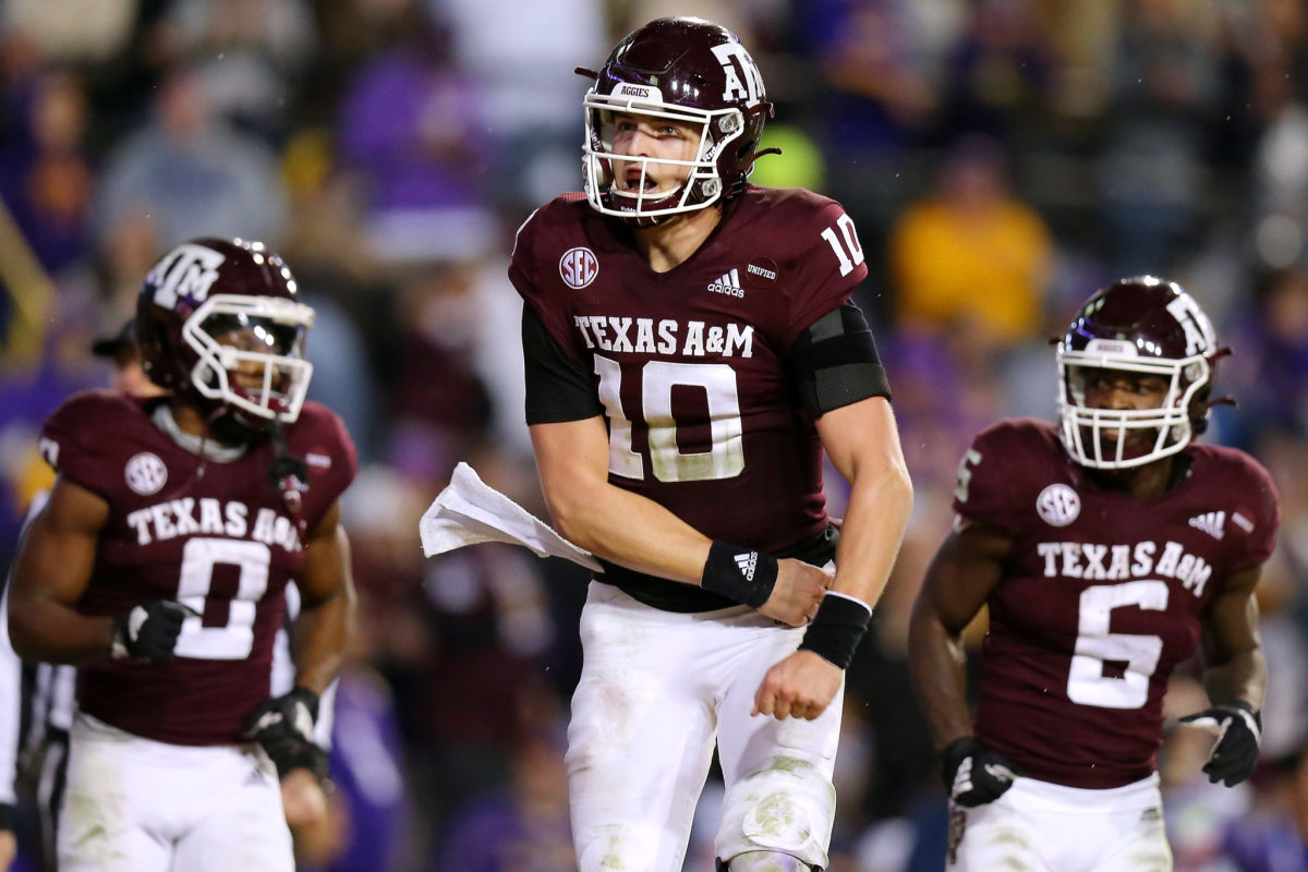 QB Zach Calzada jumps up and celebrates during a Texas A&M game.