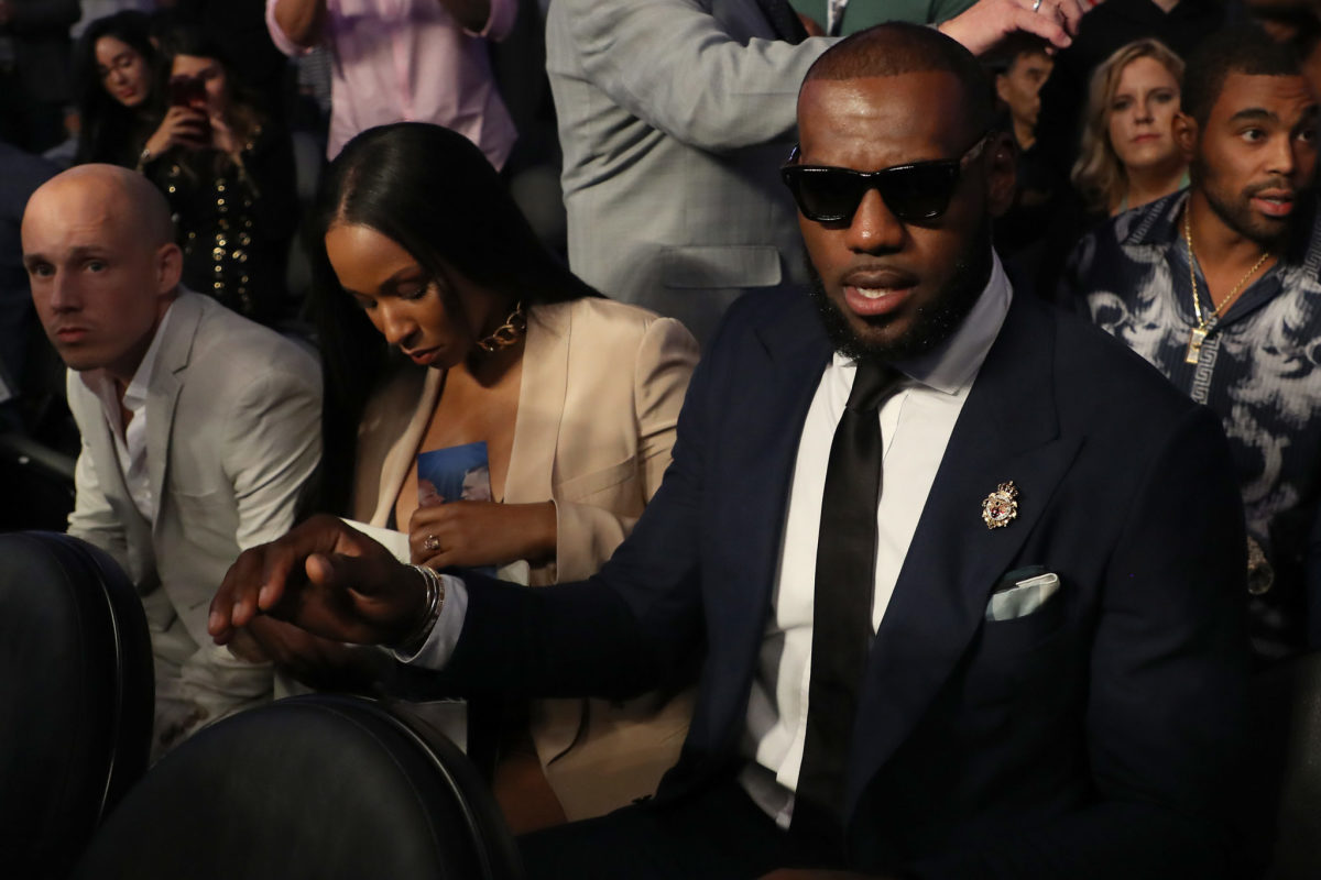 LeBron James wearing a suit at a boxing match.