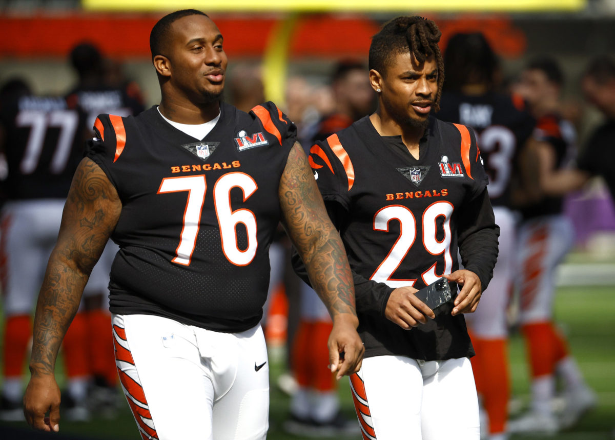 Bengals players Mike Daniels (76) and Vernon Hargreaves (29) walk on the field before the Super Bowl.