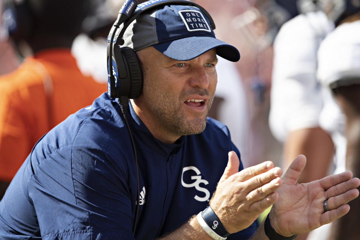 Former Georgia Southern head coach Chad Lunsford claps his hands on the sidelines.