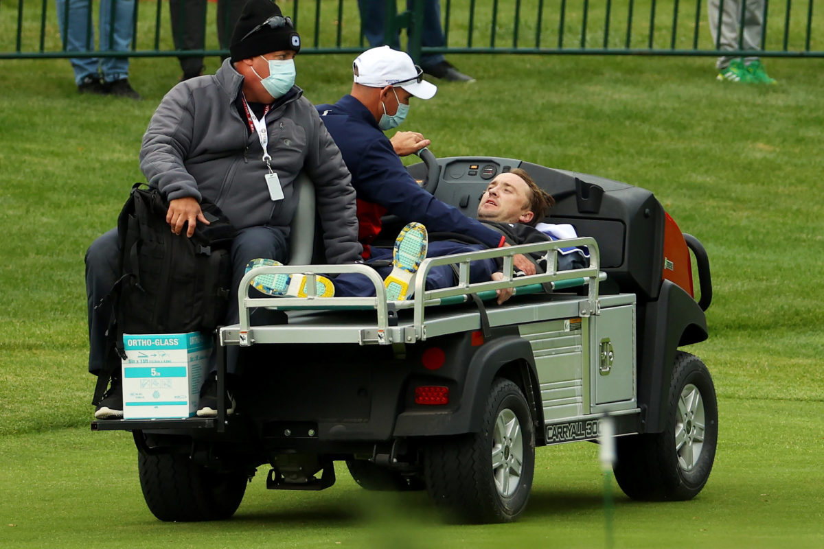 Tom Felton gets carted off the course.