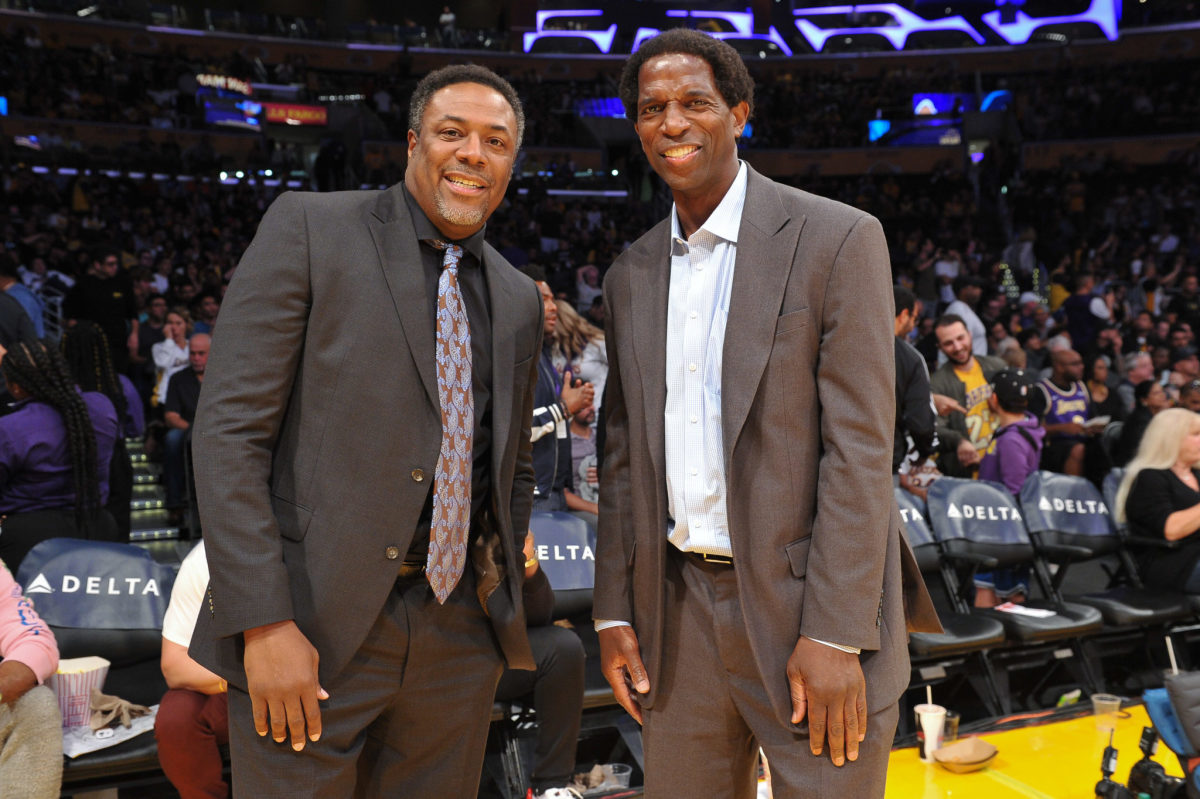 Cedric Ceballos stands with A.C. Green at a Lakers game.