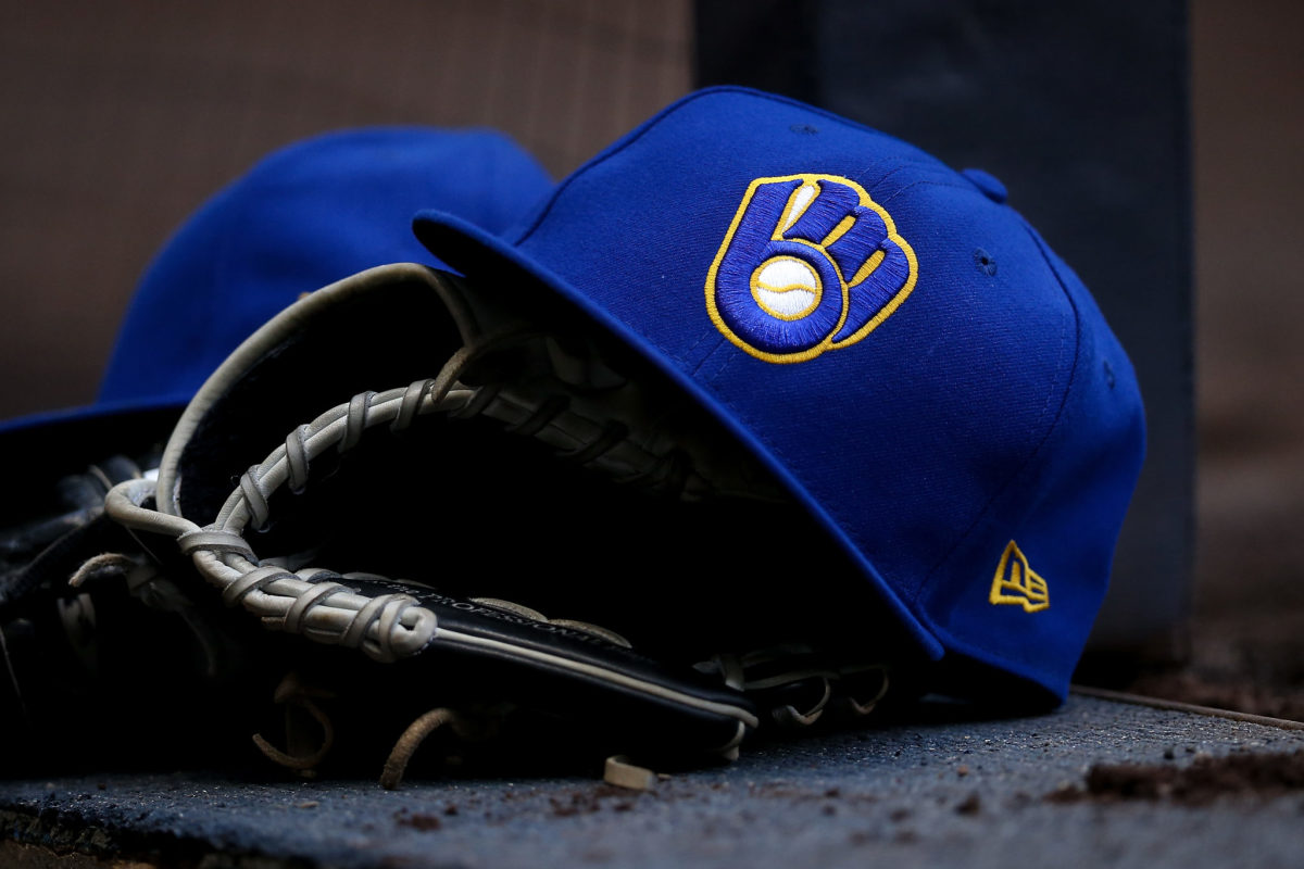 A photo of a Milwaukee Brewers hat with a glove.