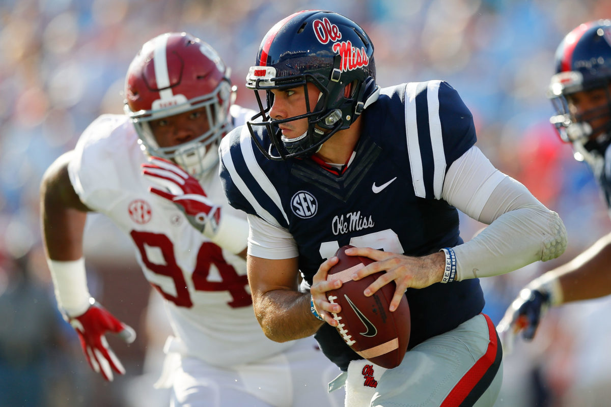 Chad Kelly tries to get away from an Alabama defender.