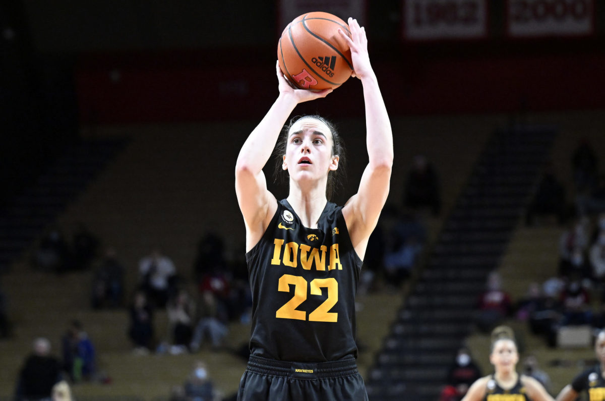 Iowa star Caitlin Clark rises up to attempt a jump shot in a game.