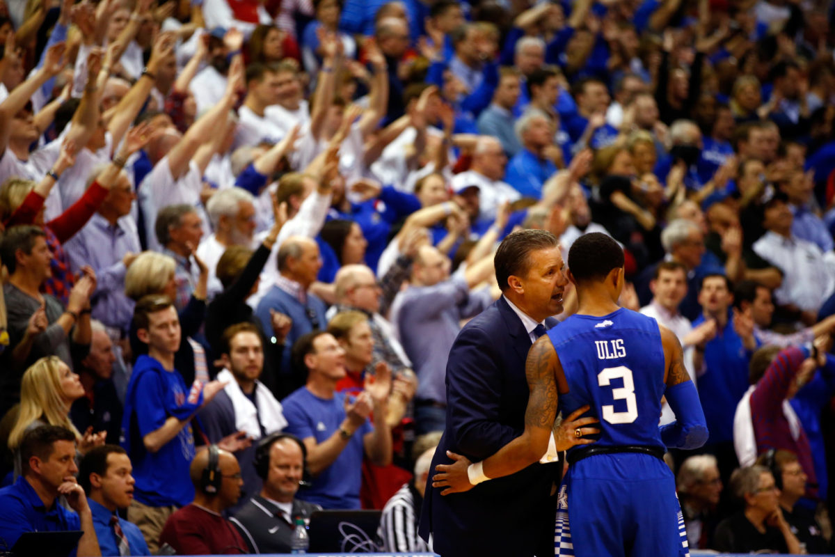 Coach Cal whispering something into Tyler Ulis' ear.