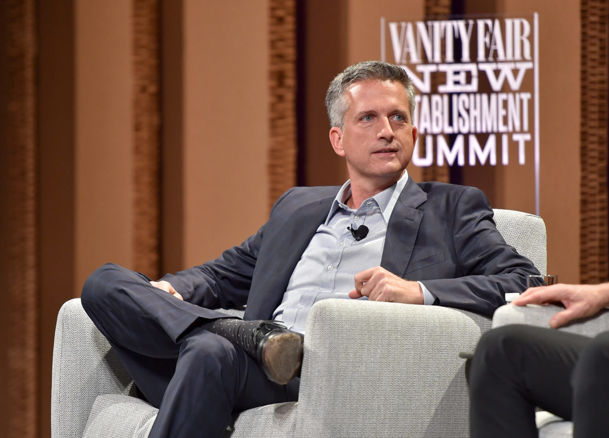 Bill Simmons sitting on stage at an event.