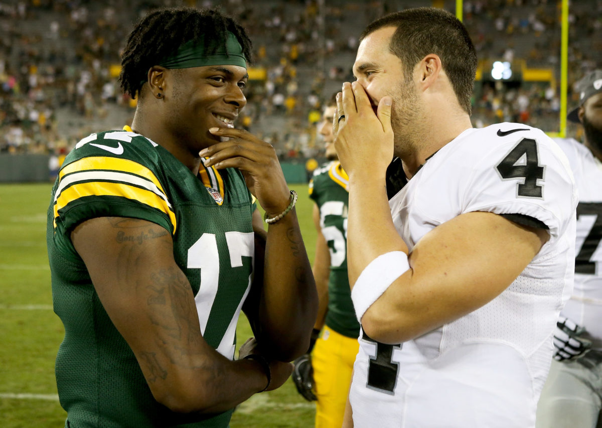 Former college teammates Davante Adams and Aaron Rodgers talking before a Packers vs. Raiders preseason game.