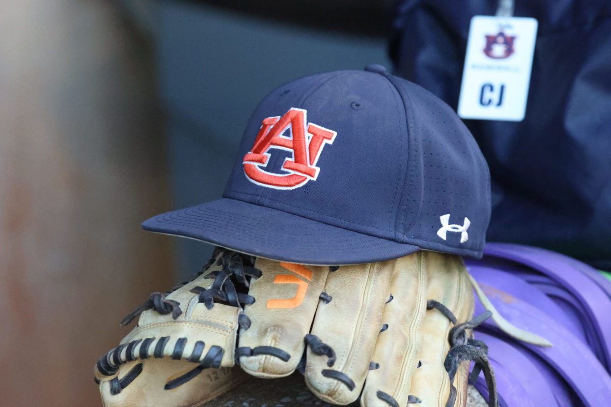 A photo of an Auburn baseball cap on top of a glove.