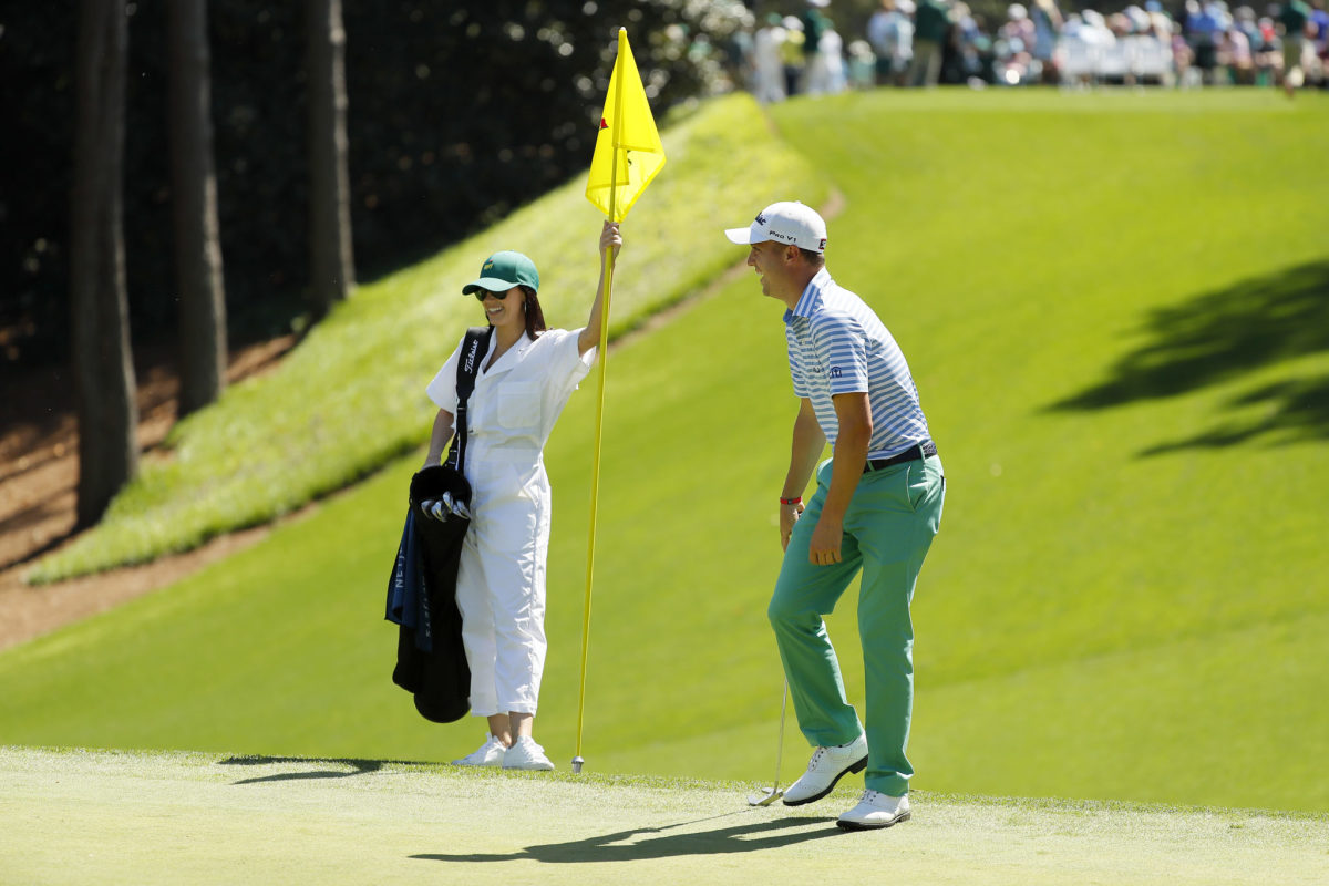 Justin Thomas with his girlfriend on the green.