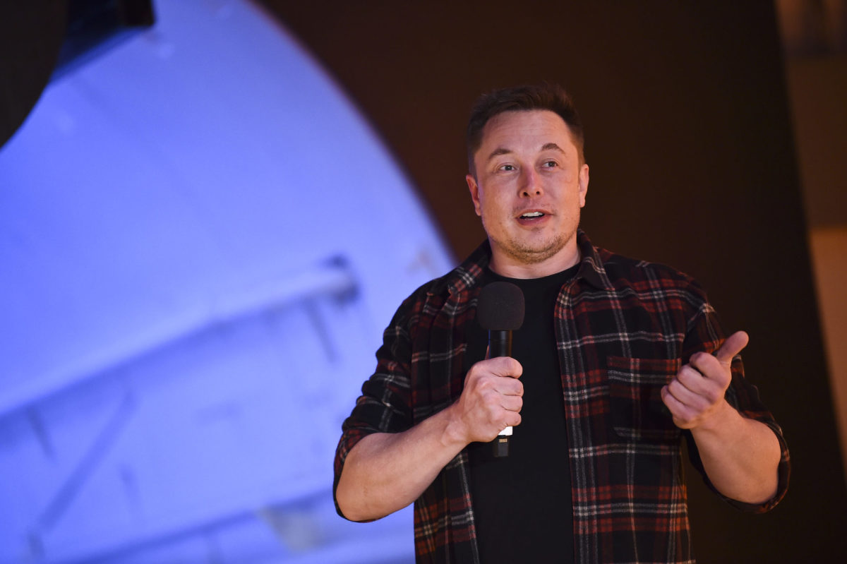 Elon Musk speaking on stage.
