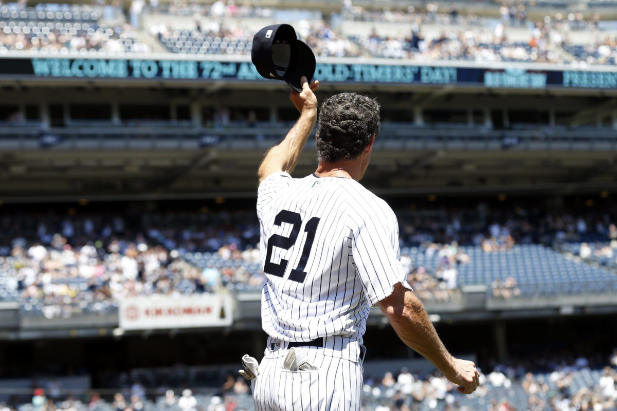 Paul O'Neill, wearing No. 21, tips his cap to the crowd at Yankee Stadium.