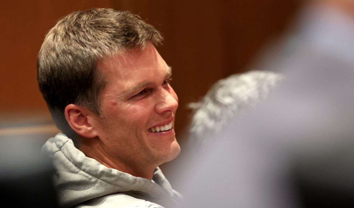 Bucs quarterback Tom Brady sits at a press conference for head coach Bruce Arians.