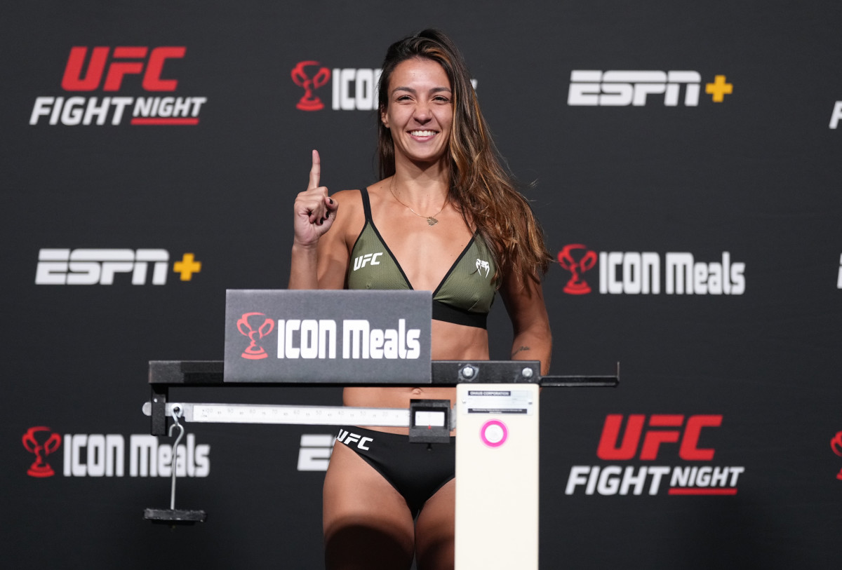 Amanda Ribas of Brazil poses on the scale before her fight on Saturday, May 14.
