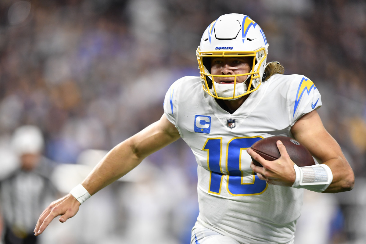 LAS VEGAS, NEVADA - JANUARY 09: Justin Herbert #10 of the Los Angeles Chargers rushes the ball during the second quarter against the Las Vegas Raiders at Allegiant Stadium on January 09, 2022 in Las Vegas, Nevada. (Photo by Chris Unger/Getty Images)