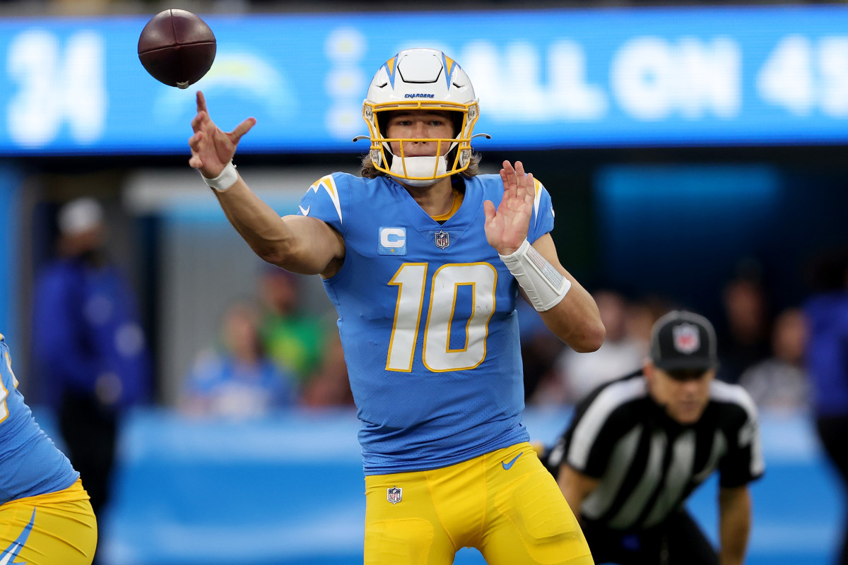 INGLEWOOD, CALIFORNIA - JANUARY 02: Justin Herbert #10 of the Los Angeles Chargers completes a pass in the fourth quarter over the Denver Broncos at SoFi Stadium on January 02, 2022 in Inglewood, California. (Photo by Sean M. Haffey/Getty Images)