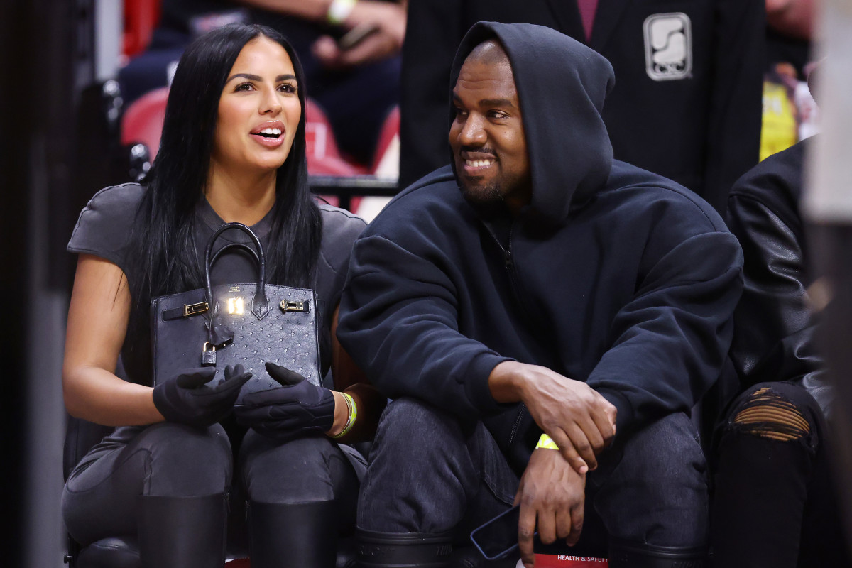 MIAMI, FLORIDA - MARCH 12: Rapper Kanye West and girlfriend Chaney Jones attend a game between the Miami Heat and the Minnesota Timberwolves at FTX Arena on March 12, 2022 in Miami, Florida. NOTE TO USER: User expressly acknowledges and agrees that, by downloading and or using this photograph, User is consenting to the terms and conditions of the Getty Images License Agreement. (Photo by Michael Reaves/Getty Images)