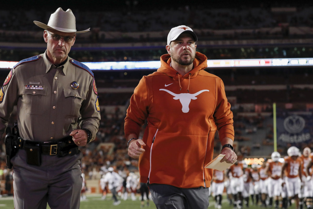 Texas head coach Tom Herman running off the field after a game vs. Iowa State.