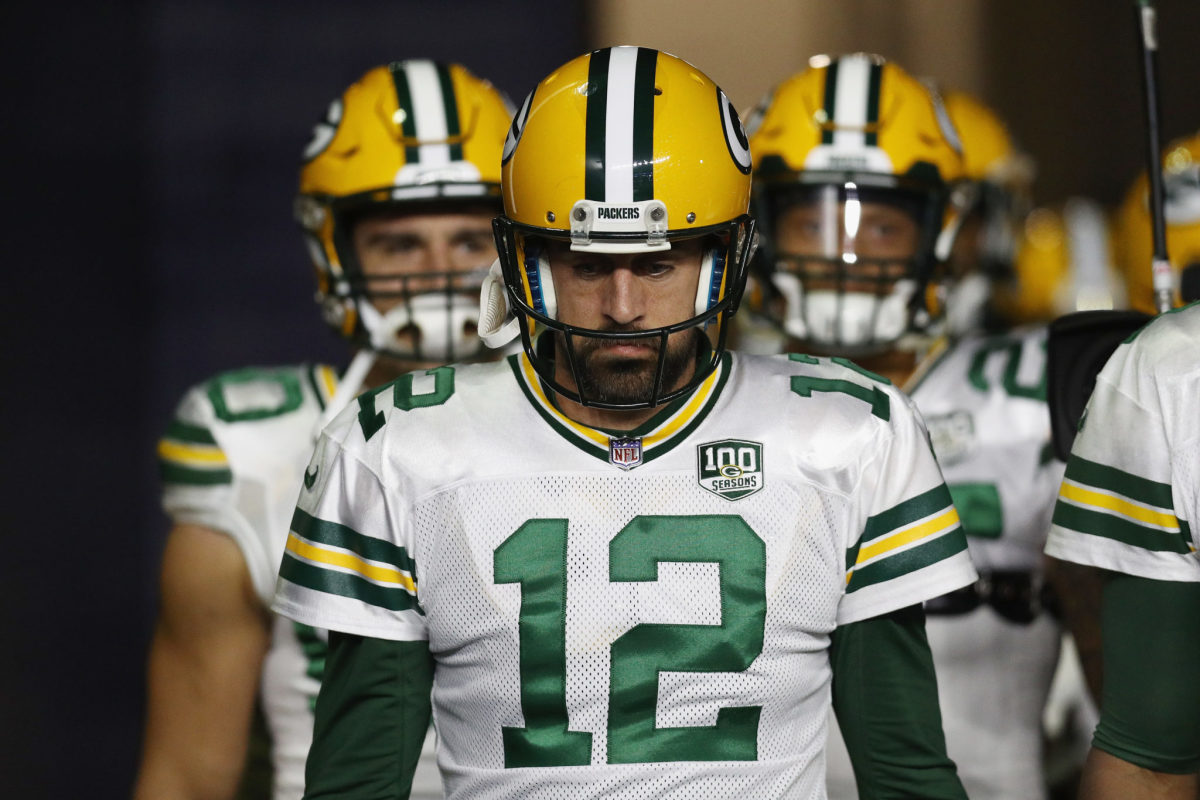 Aaron Rodgers leading his Green Bay Packers team onto the field.