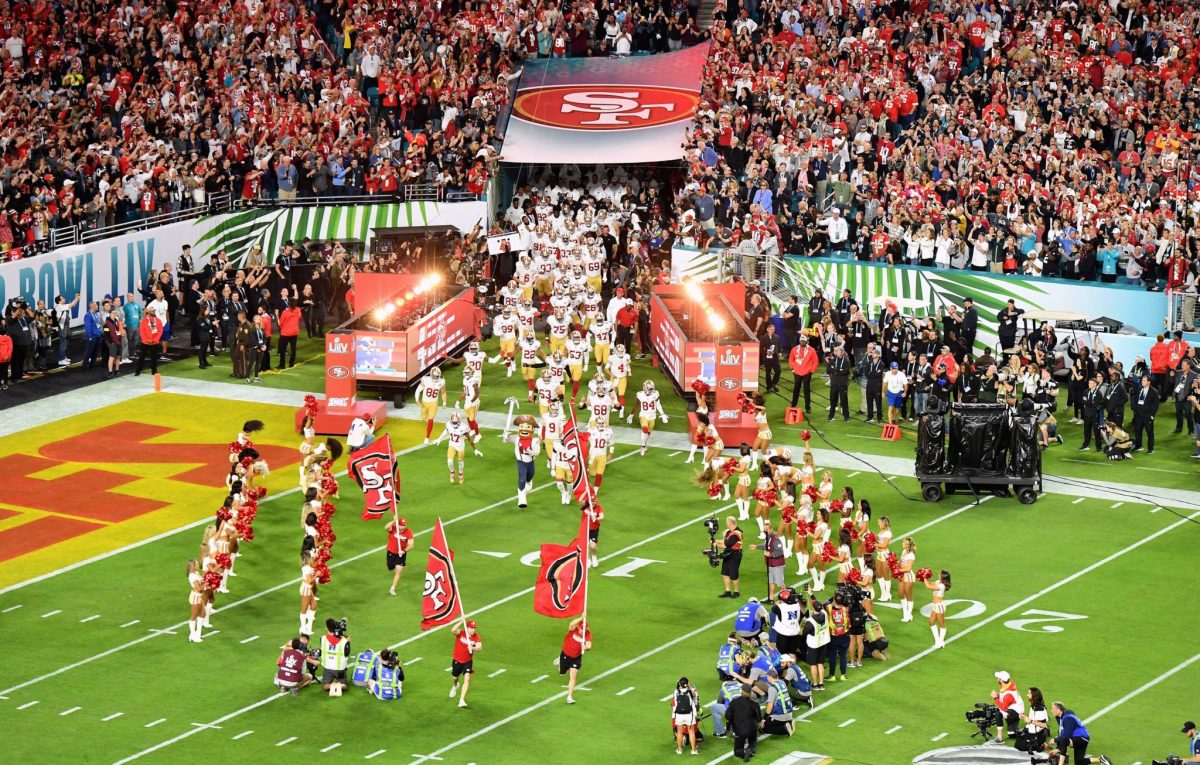 Shot of the San Francisco 49ers running onto the field.