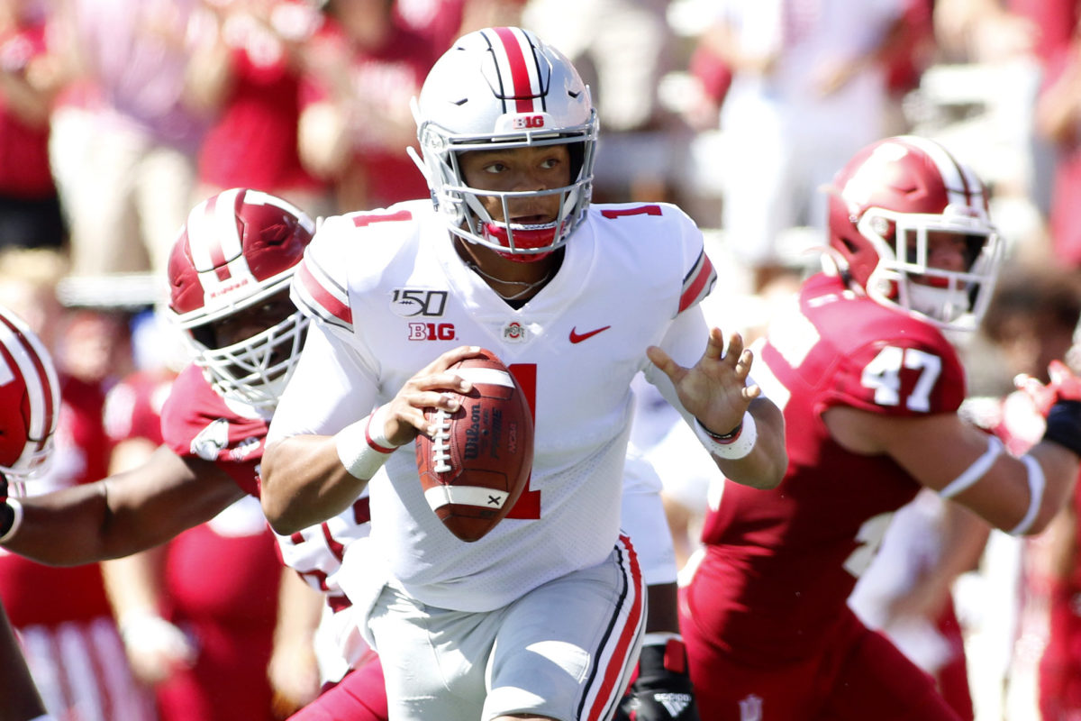 Justin Fields scrambles around the pocket for the Ohio State Buckeyes in a Big Ten college football game.