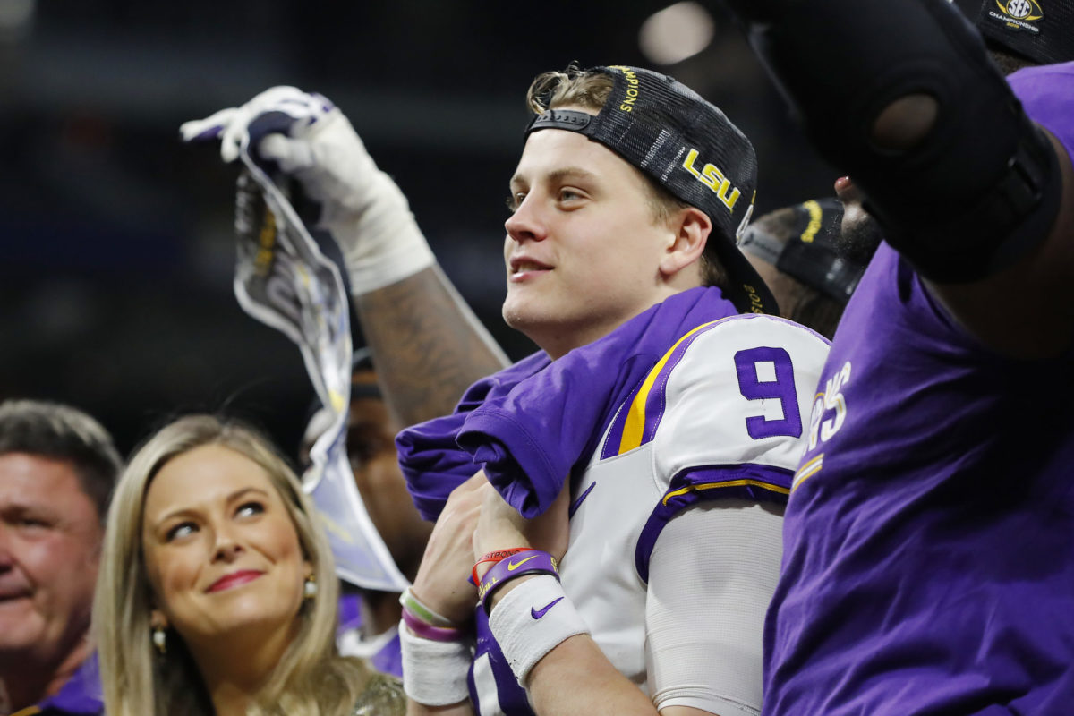 Joe Burrow celebrates LSU's win over Georgia in the SEC Championship. He is now a Miami Dolphins target in a potential trade up.