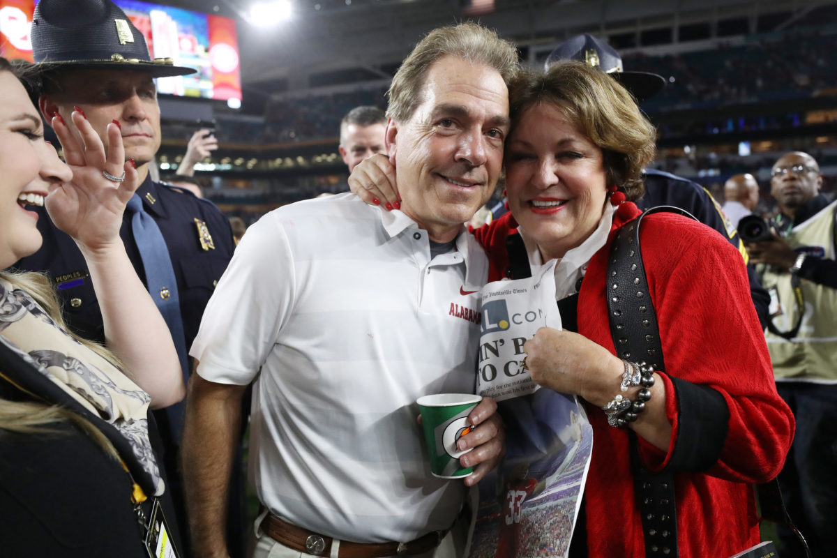Nick Saban celebrating with his wife after a game.