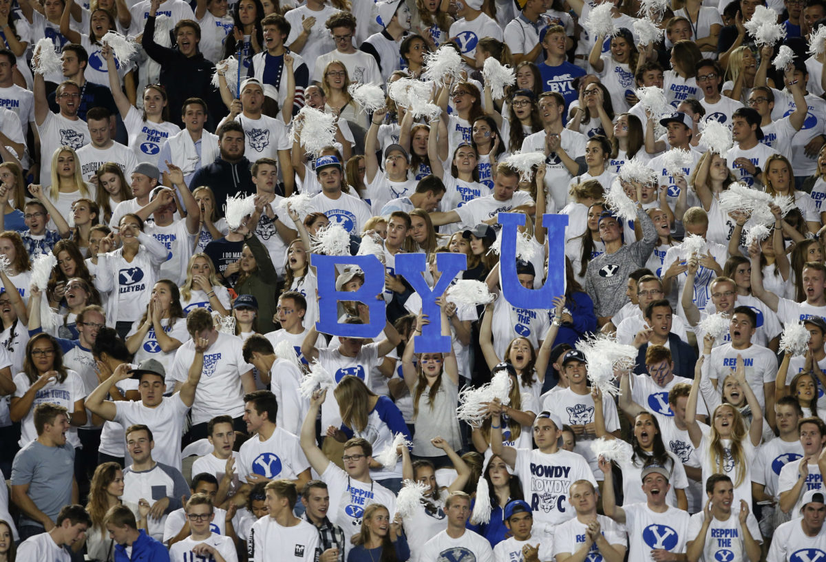 BYU fans holding up a BYU sign.