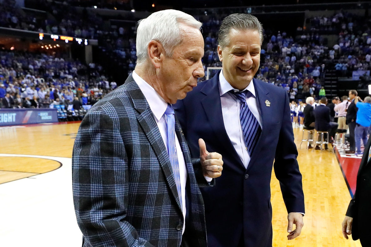Roy Williams and John Cailpari, two college basketball greats, on the court.