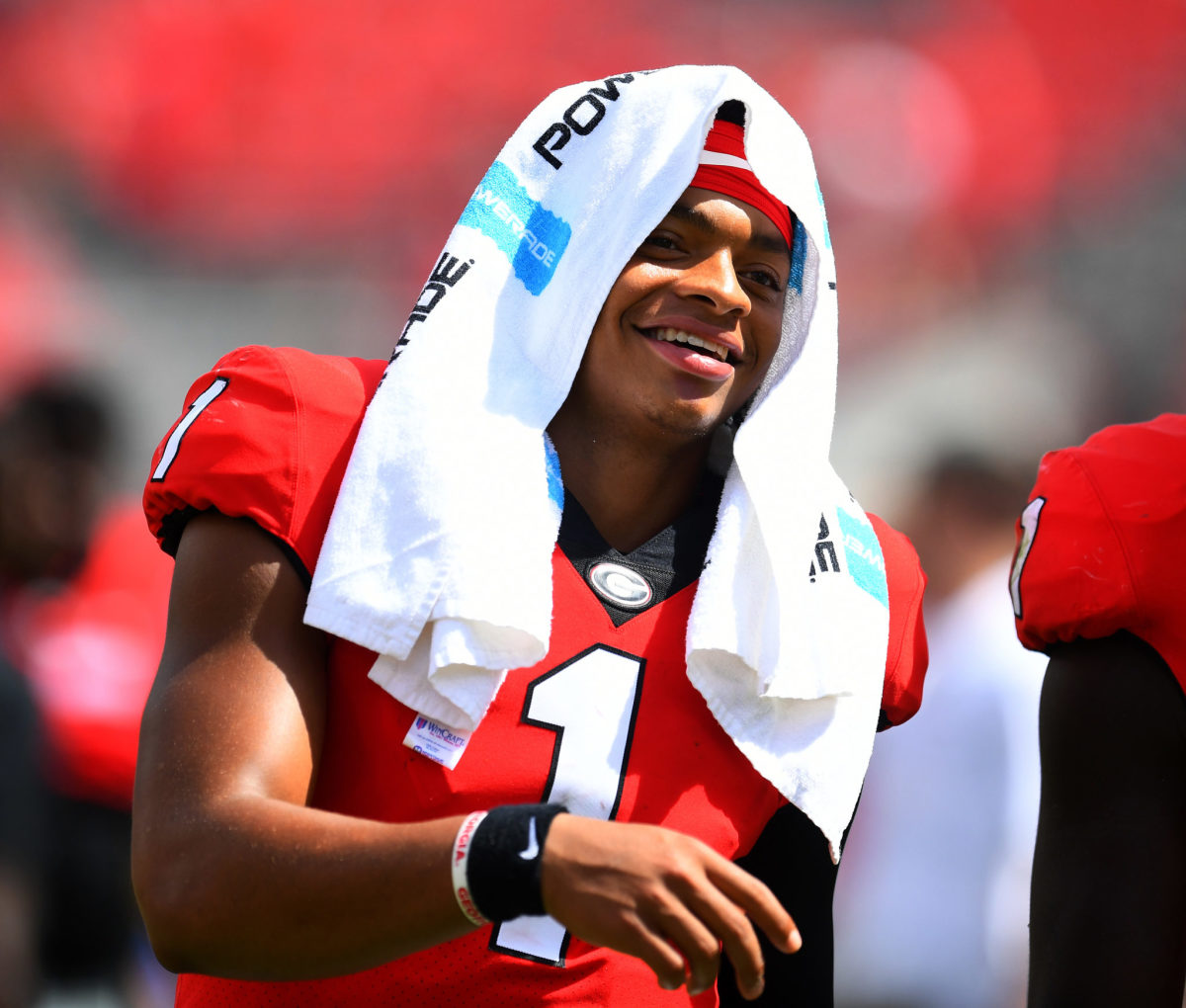justin fields smiles during a game for georgia