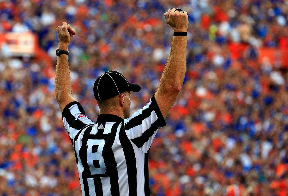 A referee signaling a touchdown during a Florida Gators game.