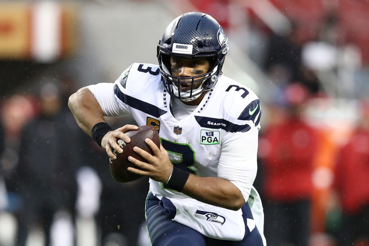Seattle Seahawks QB Russell Wilson running with the football.