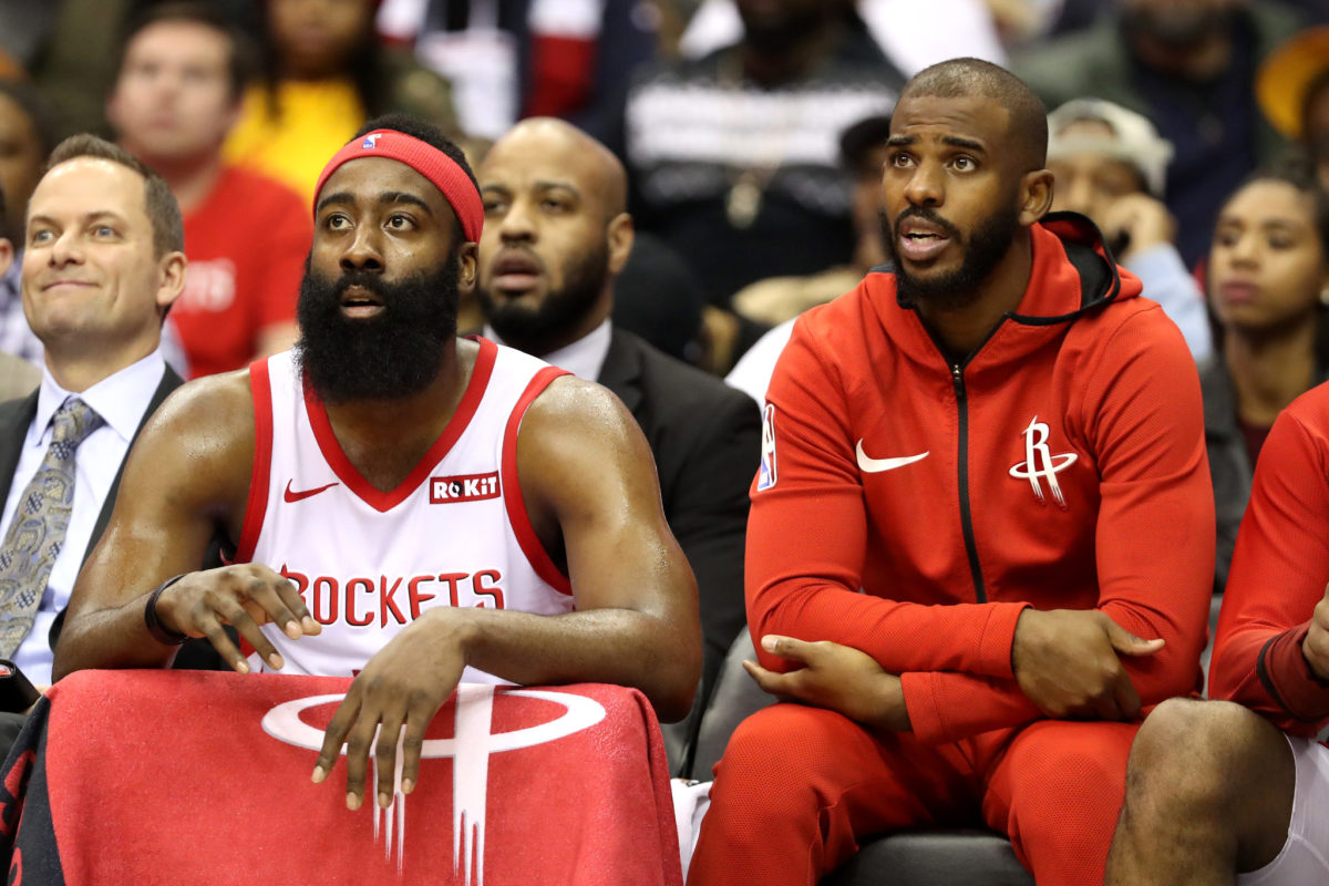 James Harden sitting on the bench with Chris Paul.