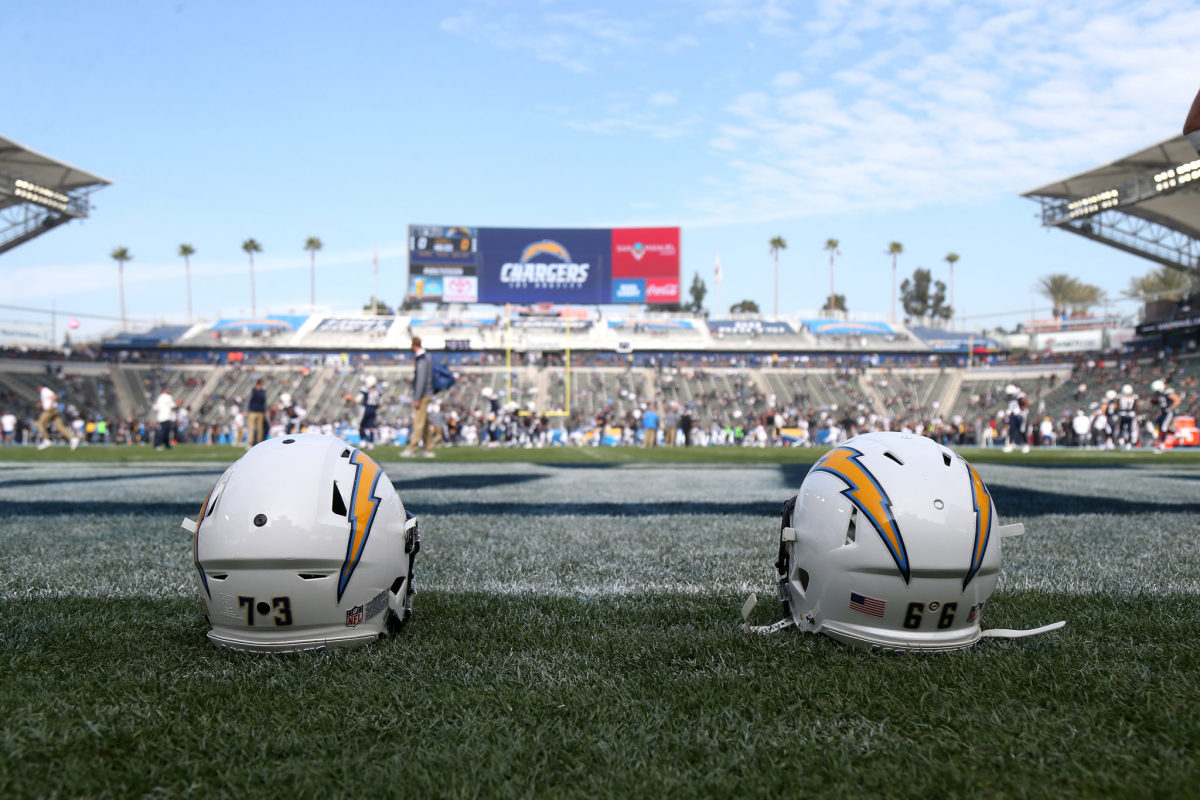 Two Los Angeles Chargers helmets sitting on the field.