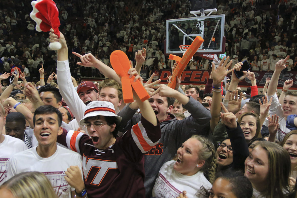 Virginia Tech students celebrate after storming the court.