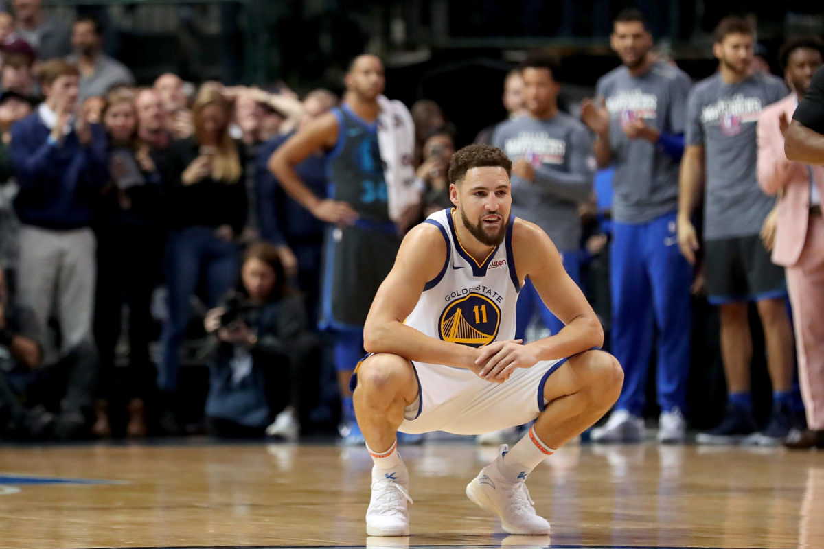 Klay Thompson squatting during a game.