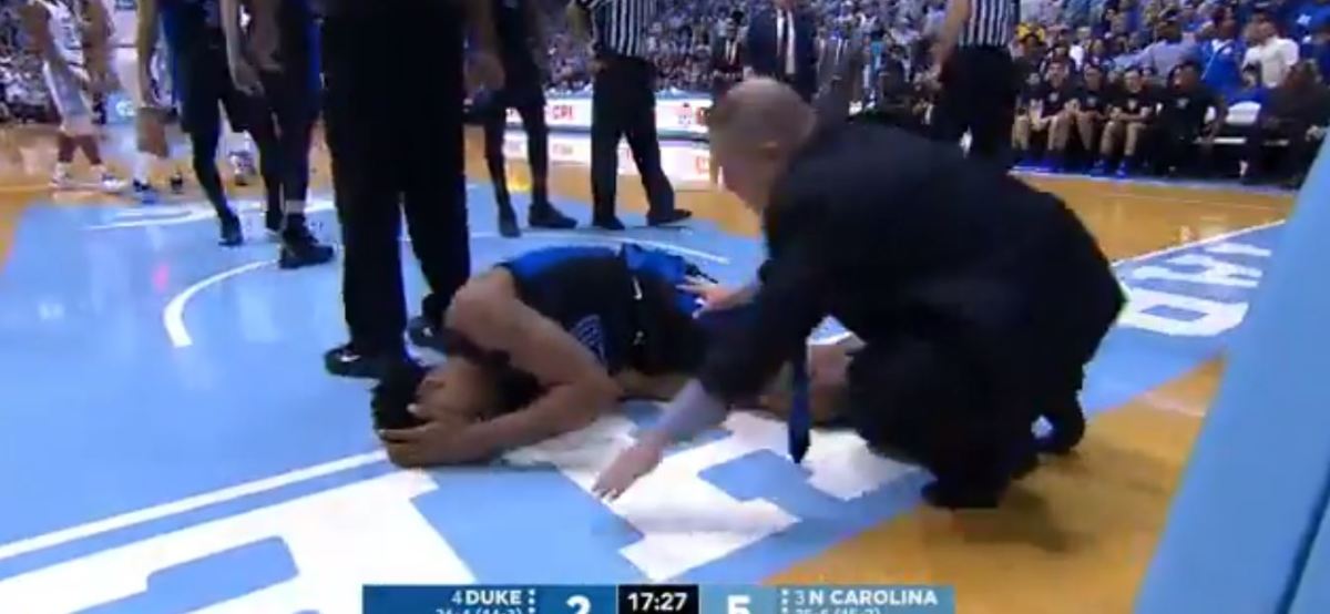 Duke's Marques Bolden down with an injury under the basket.