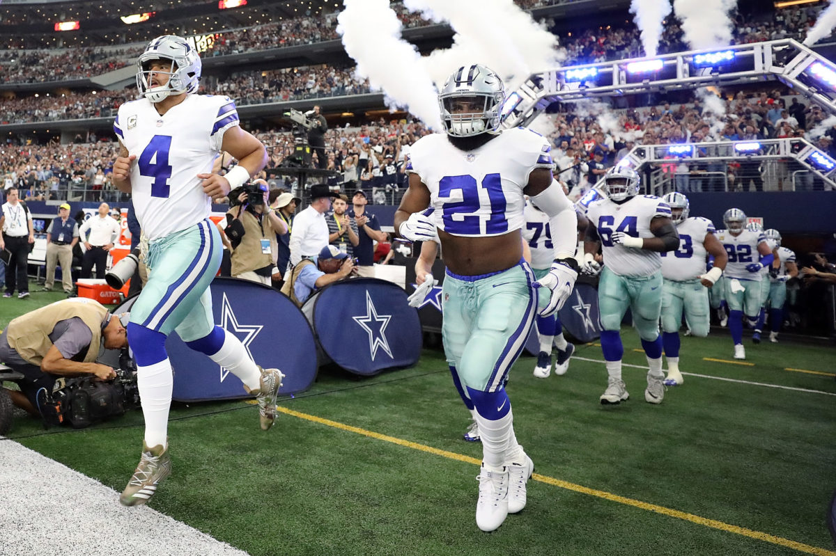 The Dallas Cowboys run onto the field before a game at AT&T Stadium.