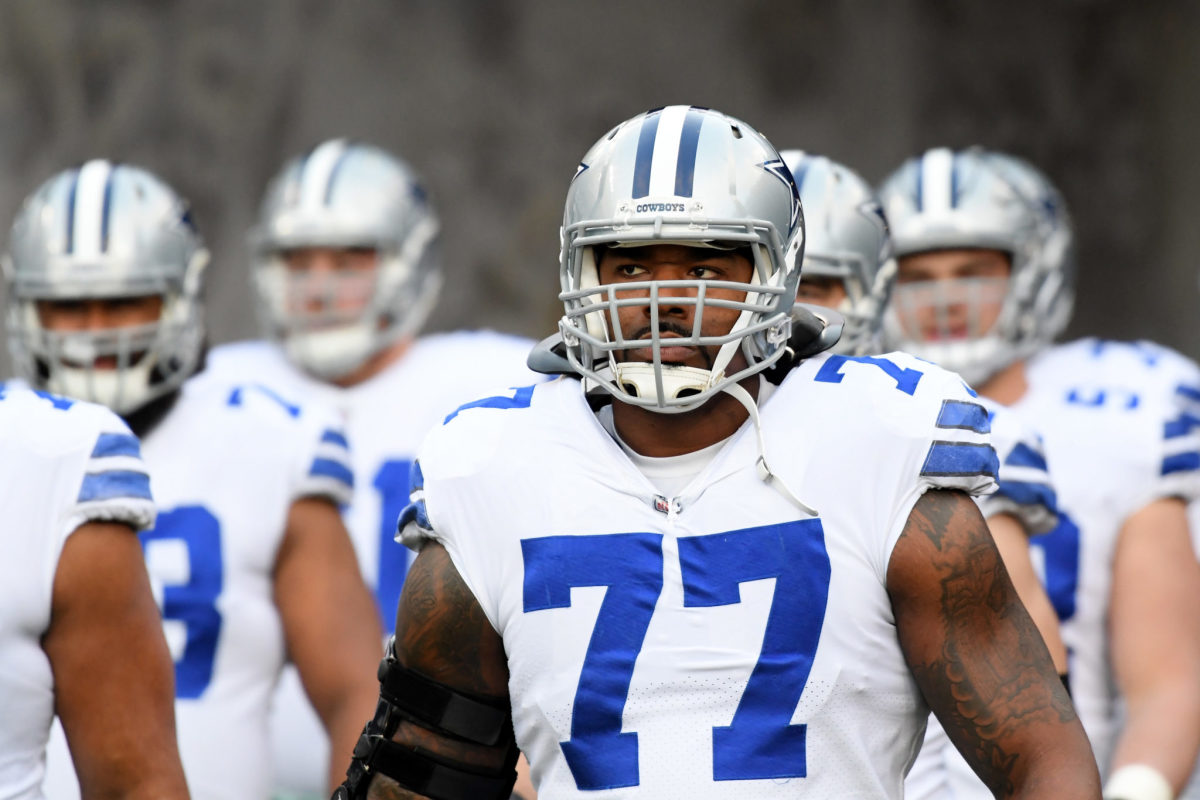 A closeup of Tyron Smith walking onto the field with his Dallas Cowboys teammates.