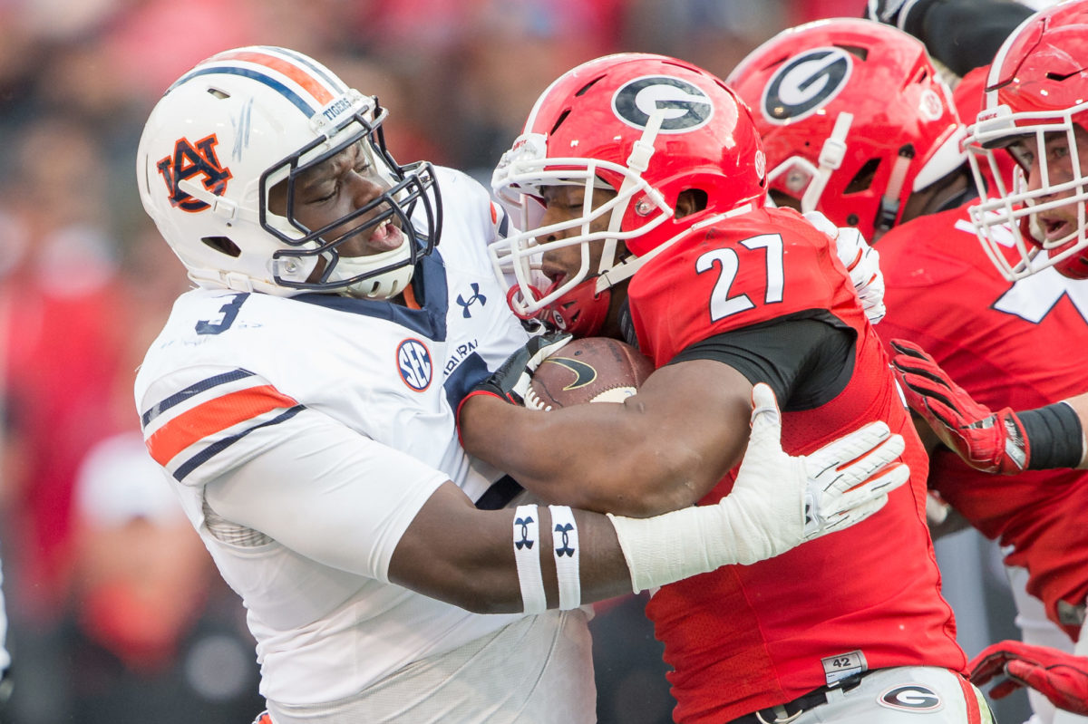 Nick Chubb tackled by an Auburn player.