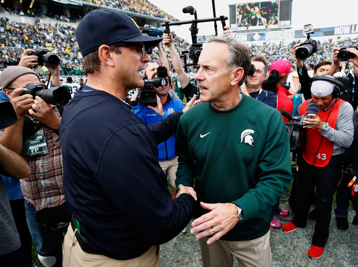 Jim Harbaugh and Mark Dantonio shaking hands after a game.