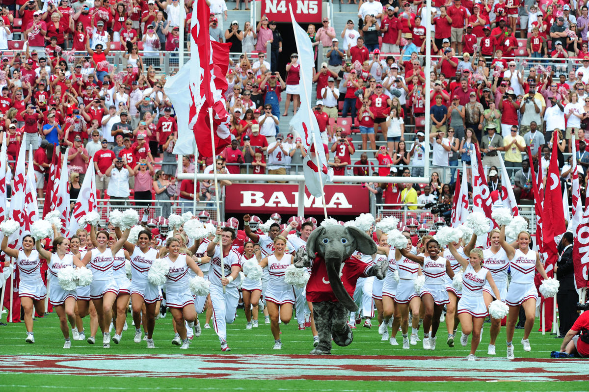 Members of the Alabama Crimson Tide take the field before the game against the Florida Atlantic Owls at Bryant-Denny Stadium.