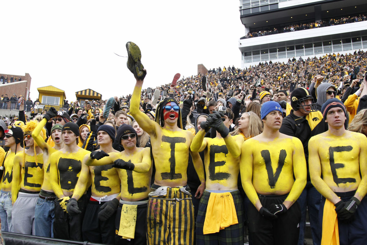 Iowa Hawkeye fans celebrating during a football game.
