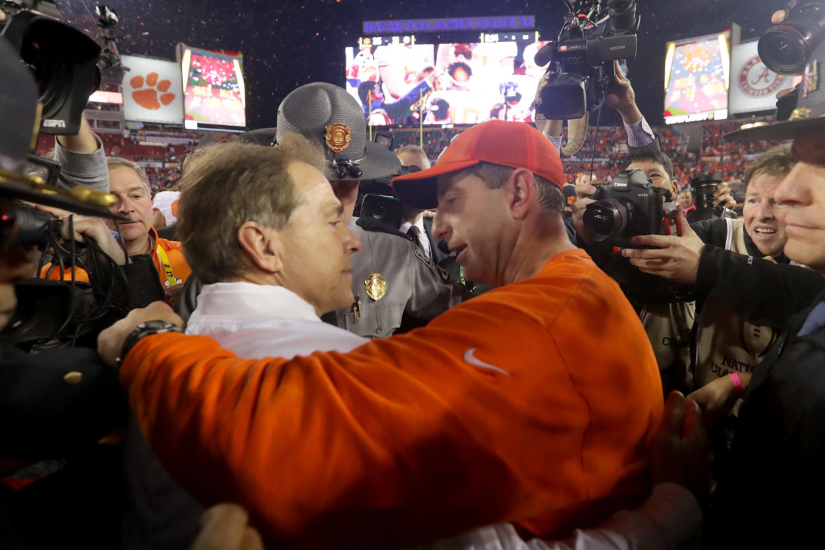 Head coach Nick Saban of the Alabama Crimson Tide talks with head coach Dabo Swinney of the Clemson Tigers after the Tigers defeated the Crimson Tide 35-31 in the 2017 College Football Playoff National Championship Game.