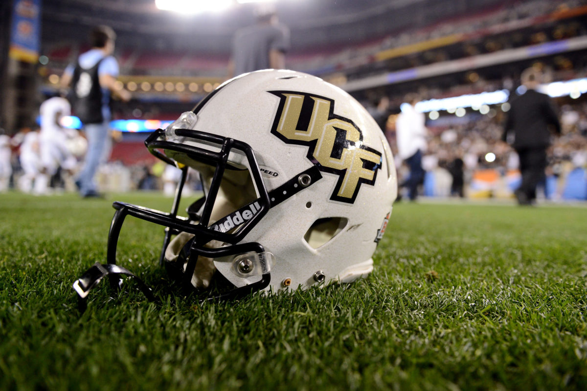 A UCF football helmet placed on the field.