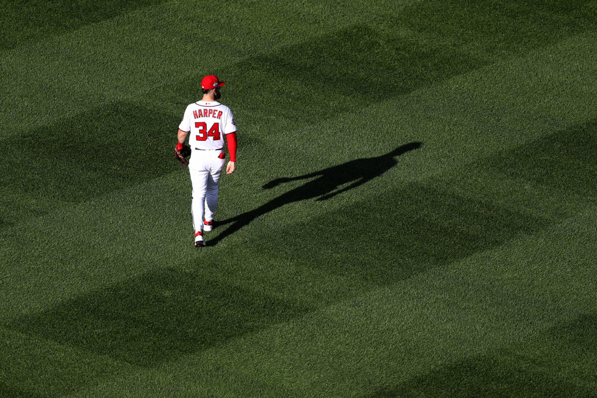 bryce harper walks onto the field before a game