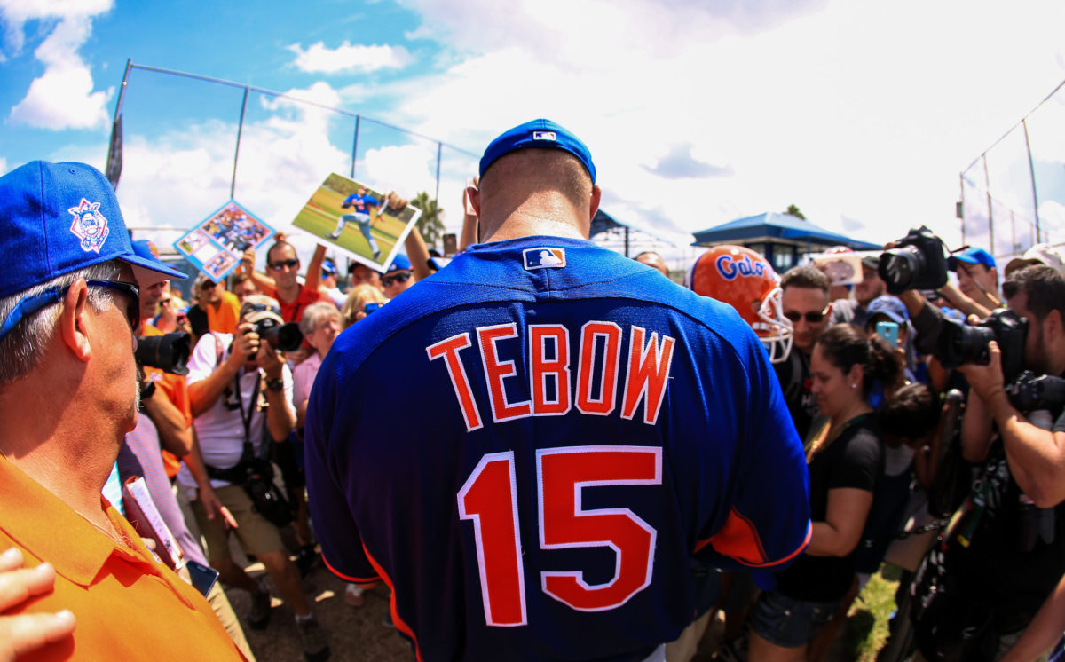 Tim Tebow signing autographs.