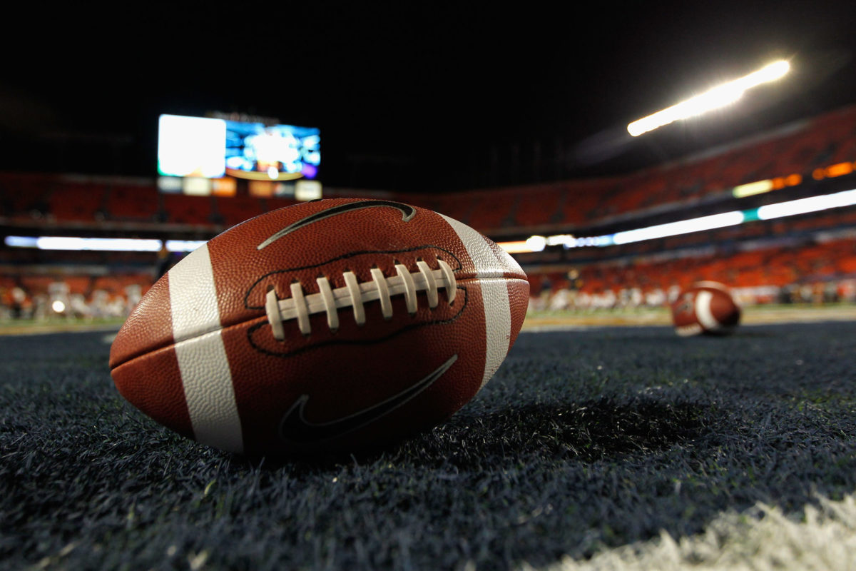 A detail of a Nike official NCAA size football as it sits in the end zone while the West Virginia Mountaineers stretchon the field prior to playing against the Clemson Tigers during the Discover Orange Bowl at Sun Life Stadium.