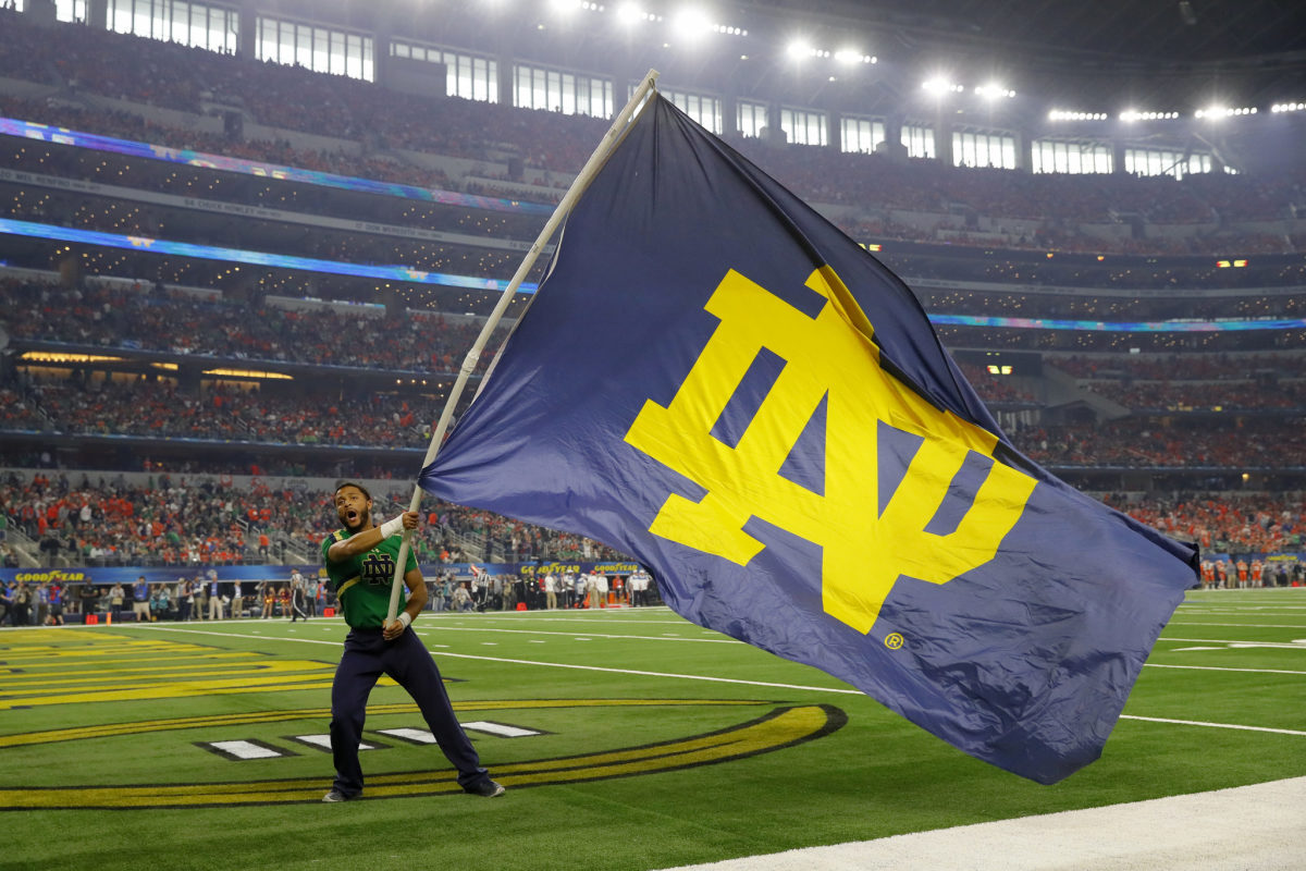 Notre Dame cheerleader waves a flag at the College Football Playoff semifinal.